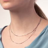 Frauen Hals mit zwei silbernen Schlangenketten mit kleinen Kugeln